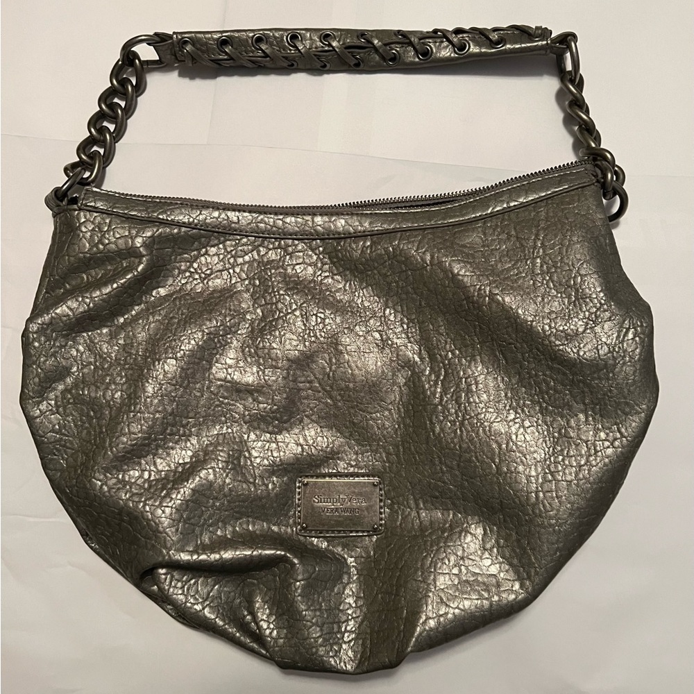 Vera Wang purse. Three inside pockets. Zips closed.